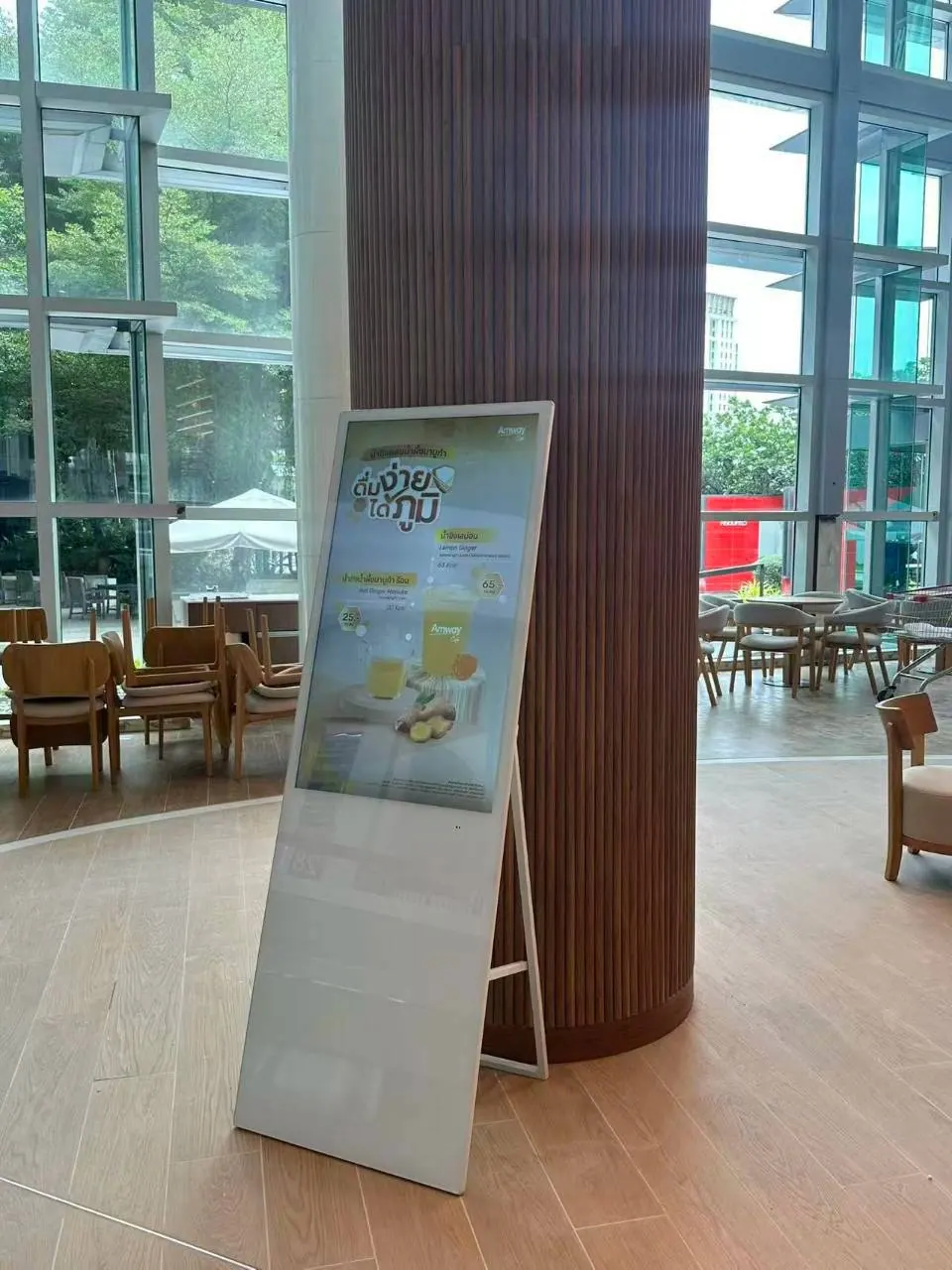 A vertical display beside a timber-clad column in a bright commercial interior